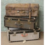 A vintage leather suitcase along with two metal bound travelling trunks to include a Mossman London