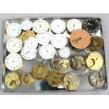 A tray of mostly antique pocket watch movements some with dials.