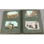A postcard album and contents of early to mid C20th colour and monochrome postcards.