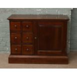 A mahogany six drawer chest /cupboard with brass mounts.