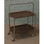 A vintage folding two tier tea trolley with chrome frame and wood effect trays.