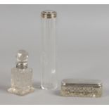 Three silver mounted glass dressing table vessels including a scent bottle with stopper.