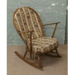 An Ercol chestnut spindle back rocking chair.