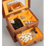 A wooden jewellery box and contents of costume jewellery including necklaces, brooches, pendant etc.