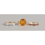 Three 9ct gold rings including a five white paste stone set example.