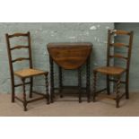 A carved oak dropleaf barleytwist gate leg table of small proportions along with a pair of bergere