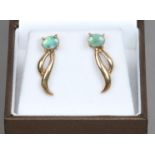A pair of 9ct gold earrings set with opals.