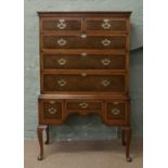 A burr walnut and mahogany chest on stand by Waring & Gillow Limited of Lancaster crossbanded and