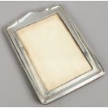 A silver photograph frame assayed Birmingham 1924 by Henry Matthews.