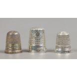 Three silver thimbles.