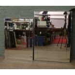 Two large bevel edge wall mirrors.