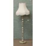 An ornate brass and onyx standard lamp with large cream shade.