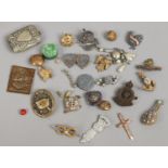 A silver jubilee tin and contents of military badges, silver A.R.
