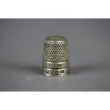 George V silver thimble, worded 'James Walker, The London Jeweller', Chester 1927