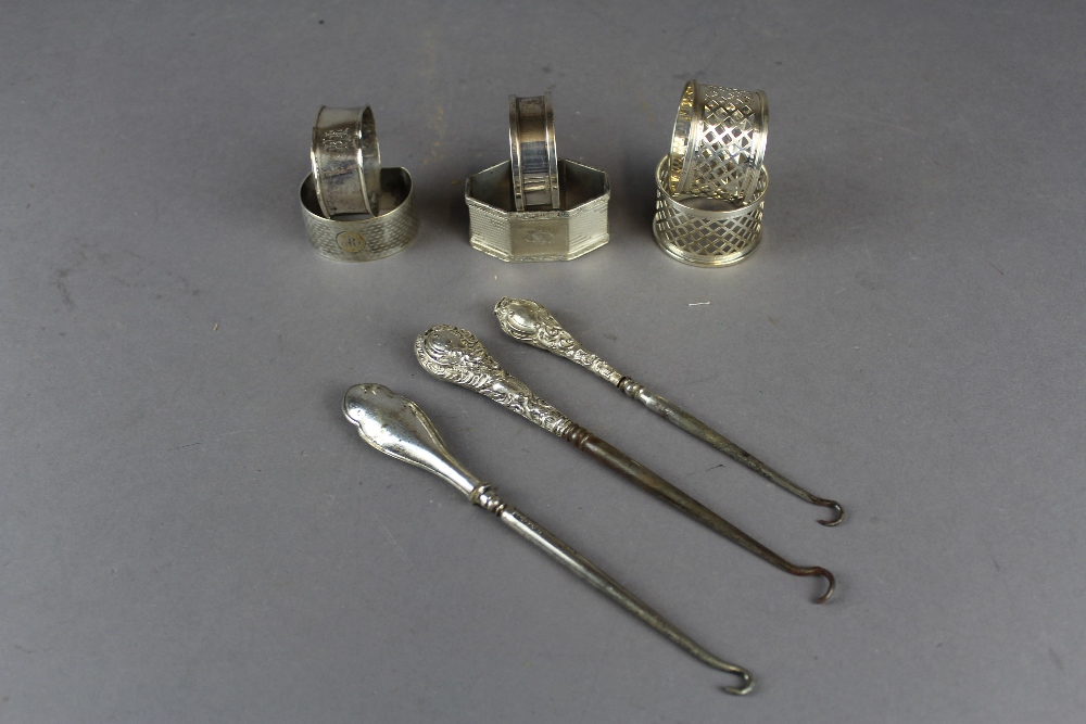 6 silver napkin rings, various and 3 button hooks