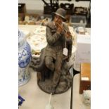 A 19th Century Continental painted terracotta figure of a shepherd playing a flute, 49cm high With