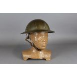 A First World War Brodie steel helmet with much original paint and textured finish, complete with