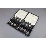 2 cased sets of matching silver coffee bean spoons