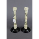 A pair of antique Chinese carved bone candlesticks