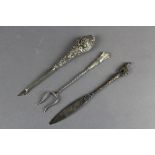French white metal paper knife with goat terminal, engraved Flumet, English silver pickle fork THH &