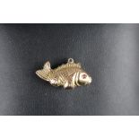 Yellow metal fish form charm marked 14k