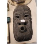 African carved and stained wood face mask