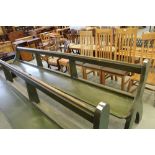 Green stained pitch pine pew with up-turned Y ends 356cm long