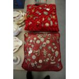 2 cushions with costume jewellery brooches