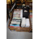 Box of various single records and collectors books