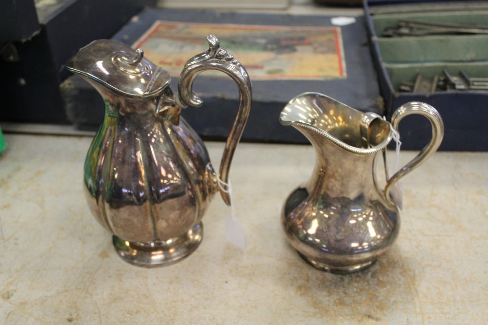 Two silver plated jugs and a pair of silver plated sugar tongs by Mappin & Webb