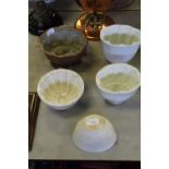 One salt glazed & 4 white pottery jelly moulds