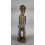 An old carved and stained wood 'Ancestor' male figure, possibly from Timor, 52cm high Cracked and