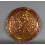 A Keswick School of Industrial Arts copper circular tray, embossed with repeating fleur-de-lis