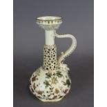 A Zsolnay Pecs porcelain reticulated oil lamp of Islamic form, decorated in colours and gilt with