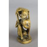 A 20th Century Eastern lightwood carving of two figures, each with stained geometric designs/tatoos,