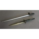 A Fairburn Commando knife (a.f.) and a spike bayonet