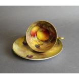 A Royal Worcester porcelain tea cup and saucer, decorated with fruit by Harry Ayrton, both signed,