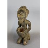 An early/mid 20th Century African painted wood carved bowl, modelled as a kneeling figure with