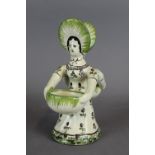 A late 19th / early 20th Century Faience pottery double salt cellar, modelled as a female figure,