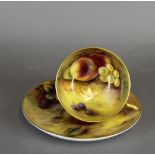 A Royal Worcester porcelain tea cup and saucer, both decorated with fruit, the cup by H Everett, the