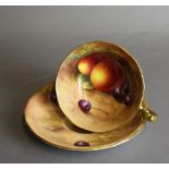 A Royal Worcester porcelain breakfast tea cup and saucer, decorated with fruit by Harry Ayrton,