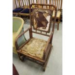 A 19th Century American oak rocking chair by Hunzinger, of spiralled design, with square back, the