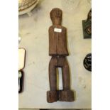 An old carved and stained wood 'Ancestor' male figure, possibly from Timor, 52cm high Cracked and