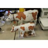 Two white glazed pottery cows by Steve Beverly Hills American Craft, 34cm and 21cm high