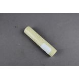 A 19th Century vegetable ivory cylindrical needle case, 8cm long, containing a 19th Century needle