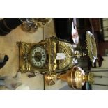 Late 19th century German brass clock with key and pendulum