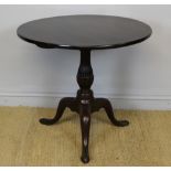 A George III mahogany circular tripod table, with fluted baluster column, 78cm diameter x 71cm