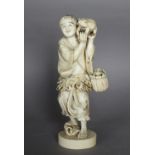 An early 20th Century Japanese carved ivory figure of a toadseller, holding toad aloft, with further