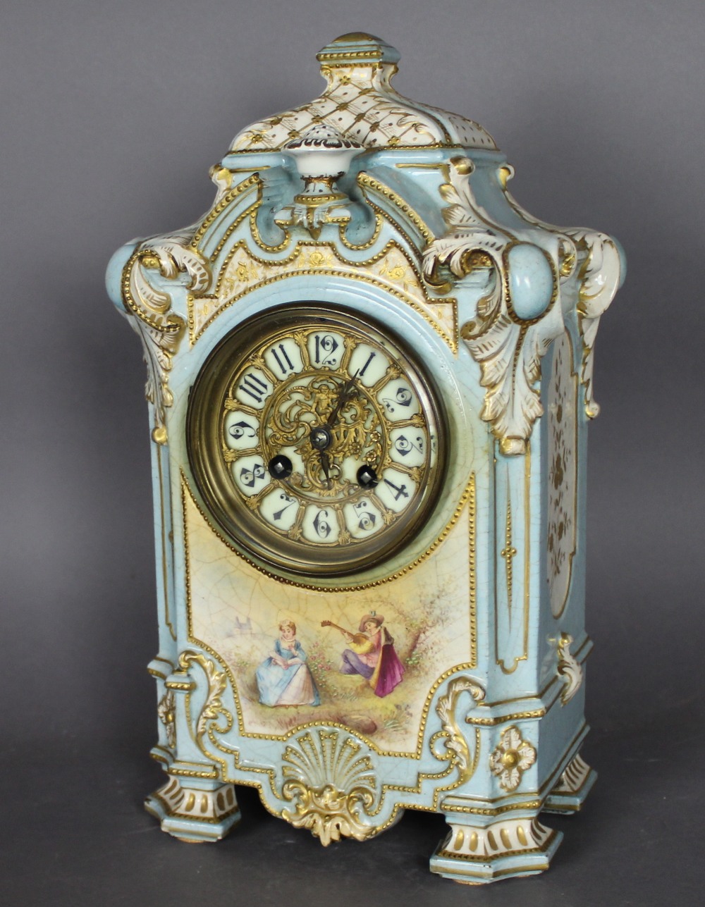 A late 19th/early 20th Century French blue glazed and gilded pottery case mantle clock, the