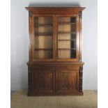 A good early Victorian figured mahogany bookcase, with moulded cornice, the upper part fitted